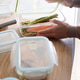 Woman opening a healthy salmon meal prep container in the kitchen Woman opening a healthy salmon meal prep container in the kitchen - PhotoDune Item for Sale