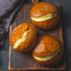 Traditional custard filled berliner pastries on a dark slate plate Traditional custard filled berliner pastries on a dark slate plate - PhotoDune Item for Sale