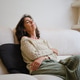 Senior woman relaxing on couch at home with closed eyes Senior woman relaxing on couch at home with closed eyes - PhotoDune Item for Sale