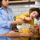 Mother holding child preparing healthy kitchen breakfast Mother holding child preparing healthy kitchen breakfast - PhotoDune Item for Sale