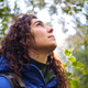 Young hiker looking up enjoying a moment of calm at the sunlight through trees in a forest Young hiker looking up enjoying a moment of calm at the sunlight through trees in a forest - PhotoDune Item for Sale