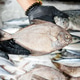 Seafood Seller Holding Fresh Pomfret Fish at Market on Ice Seafood Seller Holding Fresh Pomfret Fish at Market on Ice - PhotoDune Item for Sale