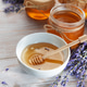 Honey jars and lavender flowers on wooden table Honey jars and lavender flowers on wooden table - PhotoDune Item for Sale