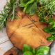 Fresh cooking herbs on rustic wooden cutting board Fresh cooking herbs on rustic wooden cutting board - PhotoDune Item for Sale