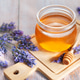 Honey jar with lavender flowers and wooden dipper Honey jar with lavender flowers and wooden dipper - PhotoDune Item for Sale