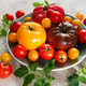 Fresh farm tomatoes displaying colorful variety on a plate Fresh farm tomatoes displaying colorful variety on a plate - PhotoDune Item for Sale