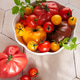 Fresh organic heirloom tomatoes in white bowl Fresh organic heirloom tomatoes in white bowl - PhotoDune Item for Sale