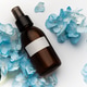 Cosmetic spray bottle with blue hydrangea petals Cosmetic spray bottle with blue hydrangea petals - PhotoDune Item for Sale