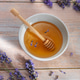 Honey bowl with dipper and lavender on wooden table Honey bowl with dipper and lavender on wooden table - PhotoDune Item for Sale