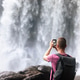 Tourist Filming Phnom Kulen Waterfall with Mobile Phone in Cambodia Tourist Filming Phnom Kulen Waterfall with Mobile Phone in Cambodia - PhotoDune Item for Sale