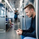 Passenger Sitting in Commuter Train Looking at Mobile Phone Passenger Sitting in Commuter Train Looking at Mobile Phone - PhotoDune Item for Sale