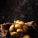 Raw uncooked potato on dark background Raw uncooked potato on dark background - PhotoDune Item for Sale