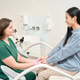 Caucasian woman in medical attire comforting another woman indoors Caucasian woman in medical attire comforting another woman indoors - PhotoDune Item for Sale