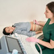 Calm Asian woman undergoing ultrasound examination in clinic Calm Asian woman undergoing ultrasound examination in clinic - PhotoDune Item for Sale