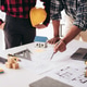 Two men are working on a drawing of a house Two men are working on a drawing of a house - PhotoDune Item for Sale