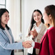 Three women are shaking hands in a business setting Three women are shaking hands in a business setting - PhotoDune Item for Sale