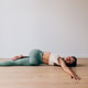 Woman doing supine spinal twist yoga pose Woman doing supine spinal twist yoga pose - PhotoDune Item for Sale
