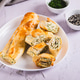 Crispy rolls with cottage cheese, cheese and dill on a plate on the table Crispy rolls with cottage cheese, cheese and dill on a plate on the table - PhotoDune Item for Sale