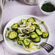 A crispy mixture of cucumbers, cabbage, onions and sesame seeds on a plate on the table vertical vie A crispy mixture of cucumbers, cabbage, onions and sesame seeds on a plate on the table vertical vie - PhotoDune Item for Sale
