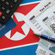 North Korean won money bills lies on table with pen, calculator, passport and tax forms North Korean won money bills lies on table with pen, calculator, passport and tax forms - PhotoDune Item for Sale