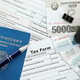 North Korean won money bills lies on table with pen, calculator, passport and tax forms North Korean won money bills lies on table with pen, calculator, passport and tax forms - PhotoDune Item for Sale