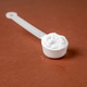 Measuring scoop with creatine powder on brown background Measuring scoop with creatine powder on brown background - PhotoDune Item for Sale