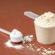 Measuring scoops with protein and creatine powders on brown background Measuring scoops with protein and creatine powders on brown background - PhotoDune Item for Sale