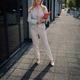 Confident businesswoman holding clipboard walking in urban street Confident businesswoman holding clipboard walking in urban street - PhotoDune Item for Sale