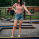 Woman enjoying a game of mini golf outdoors Woman enjoying a game of mini golf outdoors - PhotoDune Item for Sale