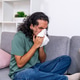 Young man blowing nose feeling unwell at home Young man blowing nose feeling unwell at home - PhotoDune Item for Sale