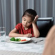 Mother is telling her cute kid eat useful vegetables but the child refuses to eat. Mother is telling her cute kid eat useful vegetables but the child refuses to eat. - PhotoDune Item for Sale