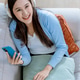 Woman listen to music on the mobile phone lying on a sofa in the living room. Woman listening music Woman listen to music on the mobile phone lying on a sofa in the living room. Woman listening music - PhotoDune Item for Sale
