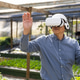 Diverse coworkers testing white VR headset, senior Asian man interacting with trays in greenhouse Diverse coworkers testing white VR headset, senior Asian man interacting with trays in greenhouse - PhotoDune Item for Sale