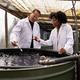 Diverse team testing bubbling green tanks at hatchery in lab coats, goggles, holding probe and vial Diverse team testing bubbling green tanks at hatchery in lab coats, goggles, holding probe and vial - PhotoDune Item for Sale