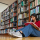 Teenage girl reads book on school library floor Teenage girl reads book on school library floor - PhotoDune Item for Sale