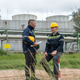 Two engineers in safety gear talking and relaxing at petroleum refinery Two engineers in safety gear talking and relaxing at petroleum refinery - PhotoDune Item for Sale