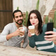 Adorable girlfriend taking a selfie with her partner Adorable girlfriend taking a selfie with her partner - PhotoDune Item for Sale