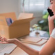 Young Asian woman online merchant talking on phone while managing laptop and shipping boxes at home Young Asian woman online merchant talking on phone while managing laptop and shipping boxes at home - PhotoDune Item for Sale