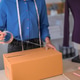 Asian small business owner packaging cardboard box for online order at home office workspace Asian small business owner packaging cardboard box for online order at home office workspace - PhotoDune Item for Sale