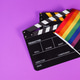 Two Clapper board and rainbow pride flag on purple or violet background. Two Clapper board and rainbow pride flag on purple or violet background. - PhotoDune Item for Sale