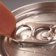 A close up view of a finger pulling up the metal tab to open a wet aluminum beverage can A close up view of a finger pulling up the metal tab to open a wet aluminum beverage can - PhotoDune Item for Sale