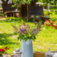 Rustic Garden Table Setting With Wildflower Bouquet In Summer Backyard, Patio Relaxation Area Rustic Garden Table Setting With Wildflower Bouquet In Summer Backyard, Patio Relaxation Area - PhotoDune Item for Sale