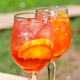 Two Glasses Or Refreshing Orange Spritz Cocktails With Ice And Citrus Slices On Sunny Summer Patio Two Glasses Or Refreshing Orange Spritz Cocktails With Ice And Citrus Slices On Sunny Summer Patio - PhotoDune Item for Sale