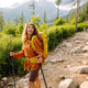Woman travels along hiking trails among mountains with yellow backpack and hiking boots. Vacation. Woman travels along hiking trails among mountains with yellow backpack and hiking boots. Vacation. - PhotoDune Item for Sale