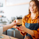 The coffee shop owner gives orders to go. Takeaway drinks concept, small business. The coffee shop owner gives orders to go. Takeaway drinks concept, small business. - PhotoDune Item for Sale