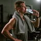 Man Drinking Water after Workout in Gym Recovery Break Man Drinking Water after Workout in Gym Recovery Break - PhotoDune Item for Sale