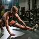 Young Adult Man Performing Lateral Lunge Stretch in Gym for Fitness Young Adult Man Performing Lateral Lunge Stretch in Gym for Fitness - PhotoDune Item for Sale