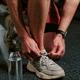 Man Tying Running Shoe before Workout in Gym Man Tying Running Shoe before Workout in Gym - PhotoDune Item for Sale