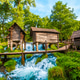 Wooden watermills on Pliva river waterfalls in Jajce, Bosnia and Herzegovina Wooden watermills on Pliva river waterfalls in Jajce, Bosnia and Herzegovina - PhotoDune Item for Sale