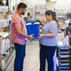 A indian young couple chooses a plastic cool box for outdoor recreation in an electronics store A indian young couple chooses a plastic cool box for outdoor recreation in an electronics store - PhotoDune Item for Sale